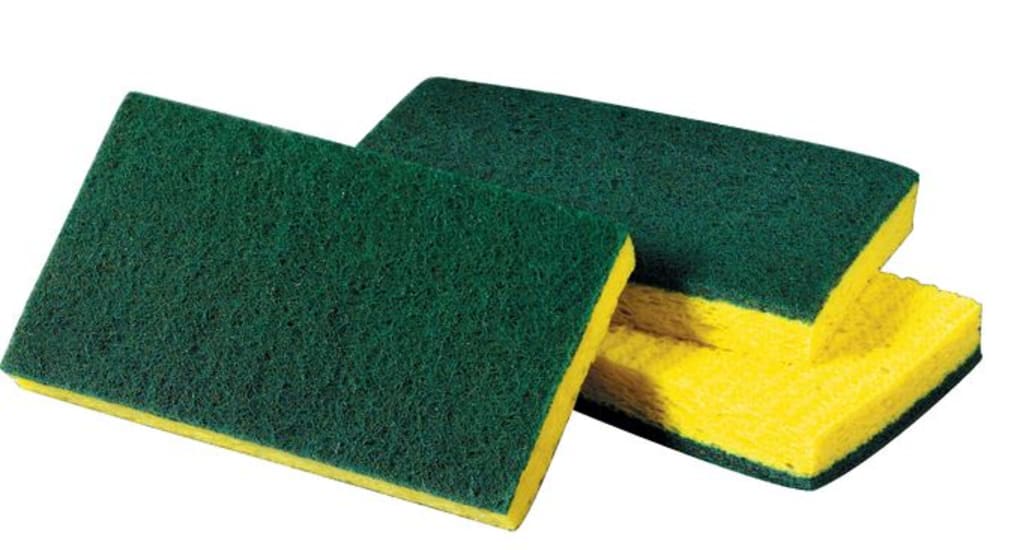 Dual-action scrub sponge with a scouring pad for tough stains and a cellulose side for quick spills, ideal for diverse cleaning tasks.