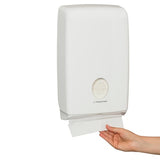 Compact white towel dispenser for KLEENEX, offers hygienic one-at-a-time dispensing in small washrooms.