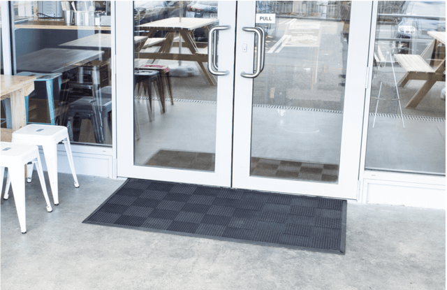 Durable black natural rubber scraper mat, 1500 x 900mm, with raised fins for effective dirt removal in high-traffic areas.
