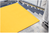 Bright yellow fibreglass floor grit panel, 1200 x 600mm, offering non-slip surface for safety in high-traffic areas.