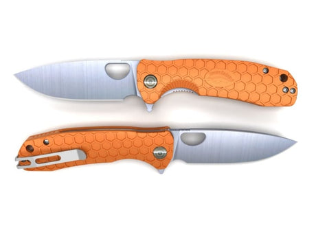 Vibrant orange Honey Badger Flipper Knife, compact design, 8Cr13Mov stainless steel blade, ball bearing pivot, and deep carry clip.