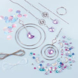 Colorful crystal suncatcher kit for tweens, includes moon gems, heart pendants, and a PlayTray for easy assembly.