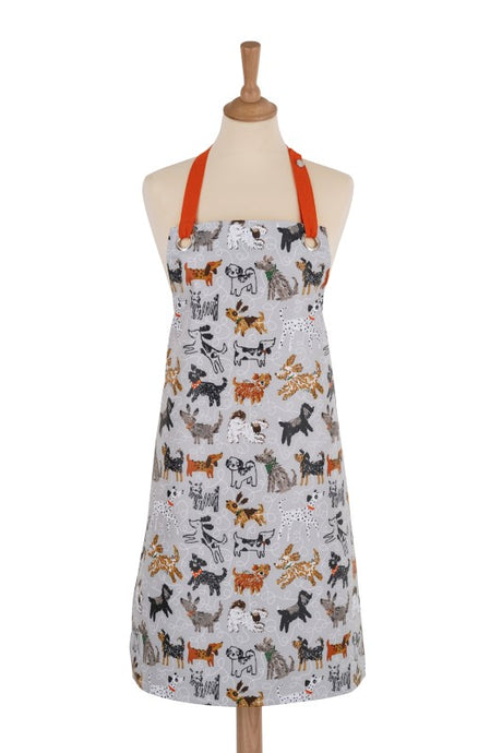 Colorful oilcloth apron featuring playful dogs in Quentin Blake's style, perfect for dog lovers and stylish cooking.