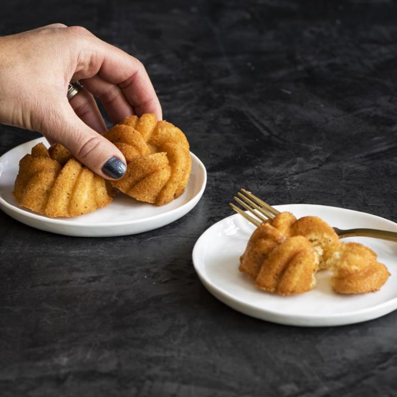 Nordic Ware 75th Anniversary Braided Mini Bundt Pan with elegant design, perfect for individual desserts and even baking.