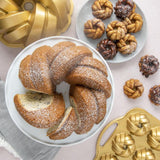 Nordic Ware 75th Anniversary Braided Mini Bundt® Pan for elegant mini cakes, crafted from durable cast aluminum, 3.5 cups capacity.