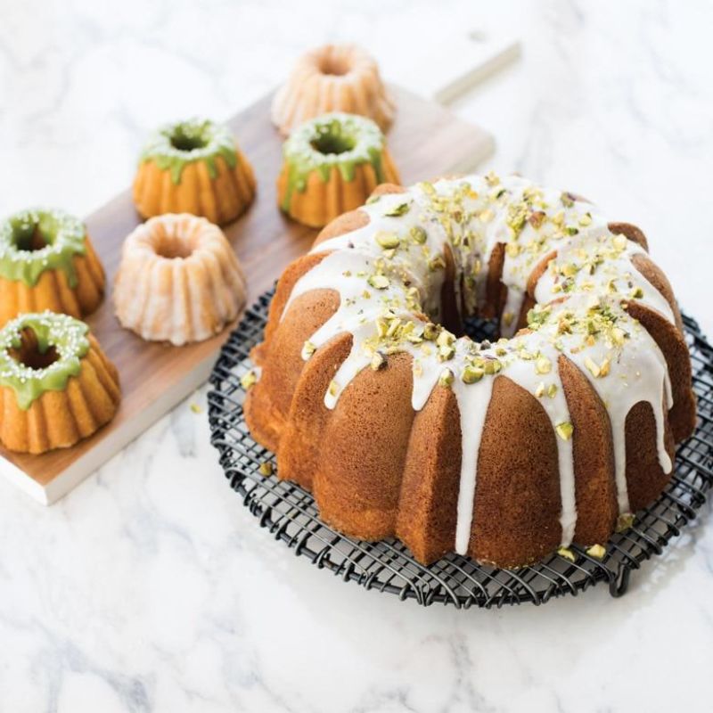 Mini Bundt pan for six elegant cakes, crafted from durable cast aluminum; ideal for baking delightful treats.