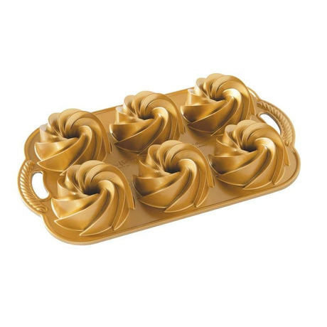 Nordic Ware Heritage Bundtlette Pan for baking 4 miniature bundt cakes, featuring intricate designs and nonstick surface.