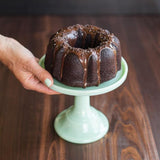 Red Nordic Ware 3 Cup Bundt Pan designed for mini Bundt cakes and gelatin molds, featuring nonstick interior for easy release.