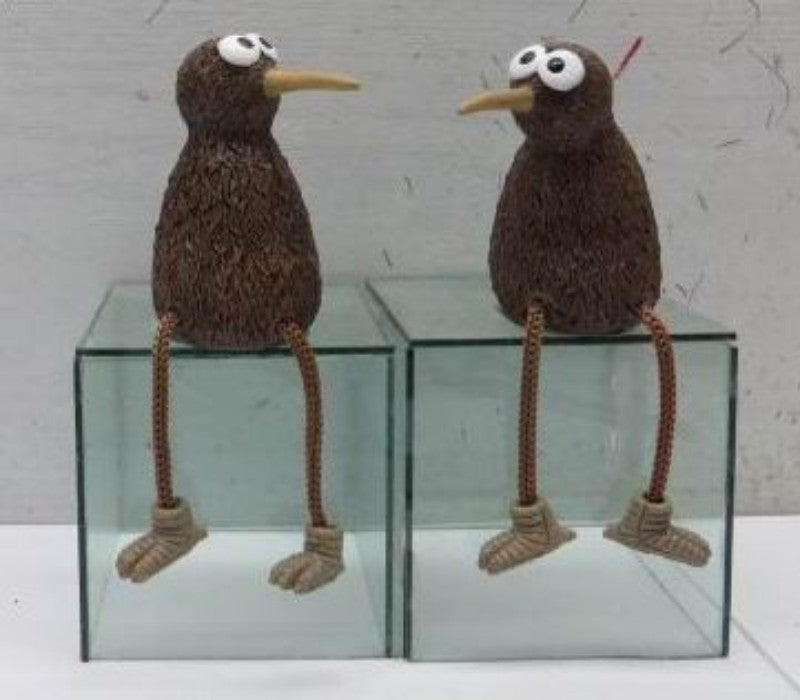 Whimsical pair of kiwi ornaments with dangling legs, perfect for home decor or unique gifts, showcasing New Zealand charm.