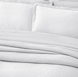 White stonewashed bedspread set with textured design and mitred corners, includes California King bedspread and two pillowcases.