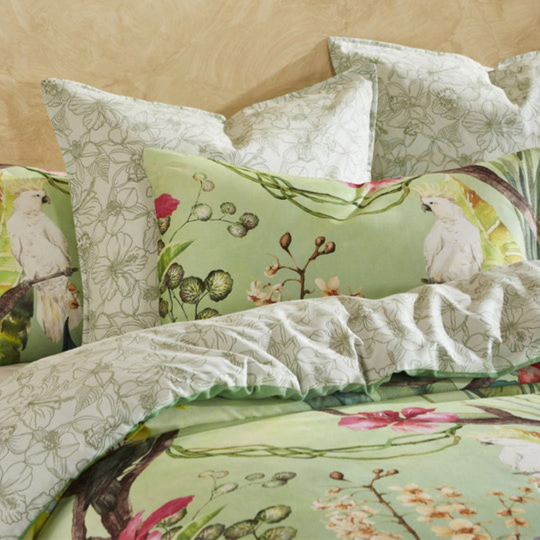 Super King duvet cover set in Aviary Green with tropical foliage and flowers, featuring reversible design and 100% cotton sateen.