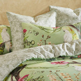 Super King duvet cover set in Aviary Green with tropical foliage and flowers, featuring reversible design and 100% cotton sateen.