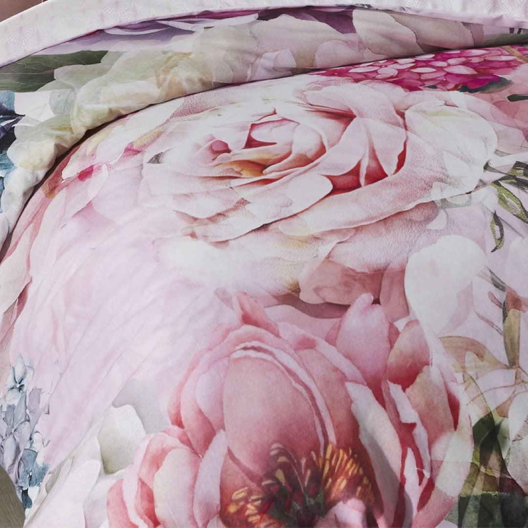 Super King Duvet Cover Set with vibrant pink floral design, soft cotton sateen fabric, and contrasting geo print reverse.