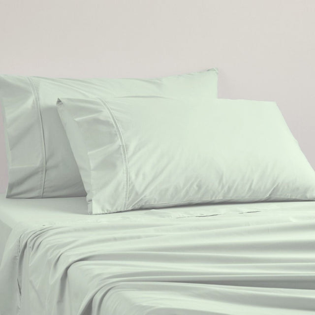 Sage green standard pillowcase by Logan and Mason, made of soft 250TC poly/cotton percale for comfort and durability.