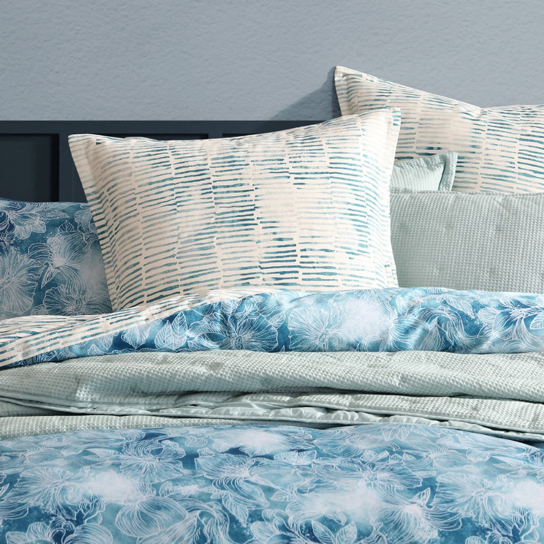 Logan and Mason Kiama Blue Queen Duvet Cover Set featuring tranquil coastal florals and soft 100% cotton sateen fabric.