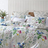 "Logan and Mason Floriana Ivory Super King Duvet Cover Set featuring a vibrant floral design on ivory cotton sateen."