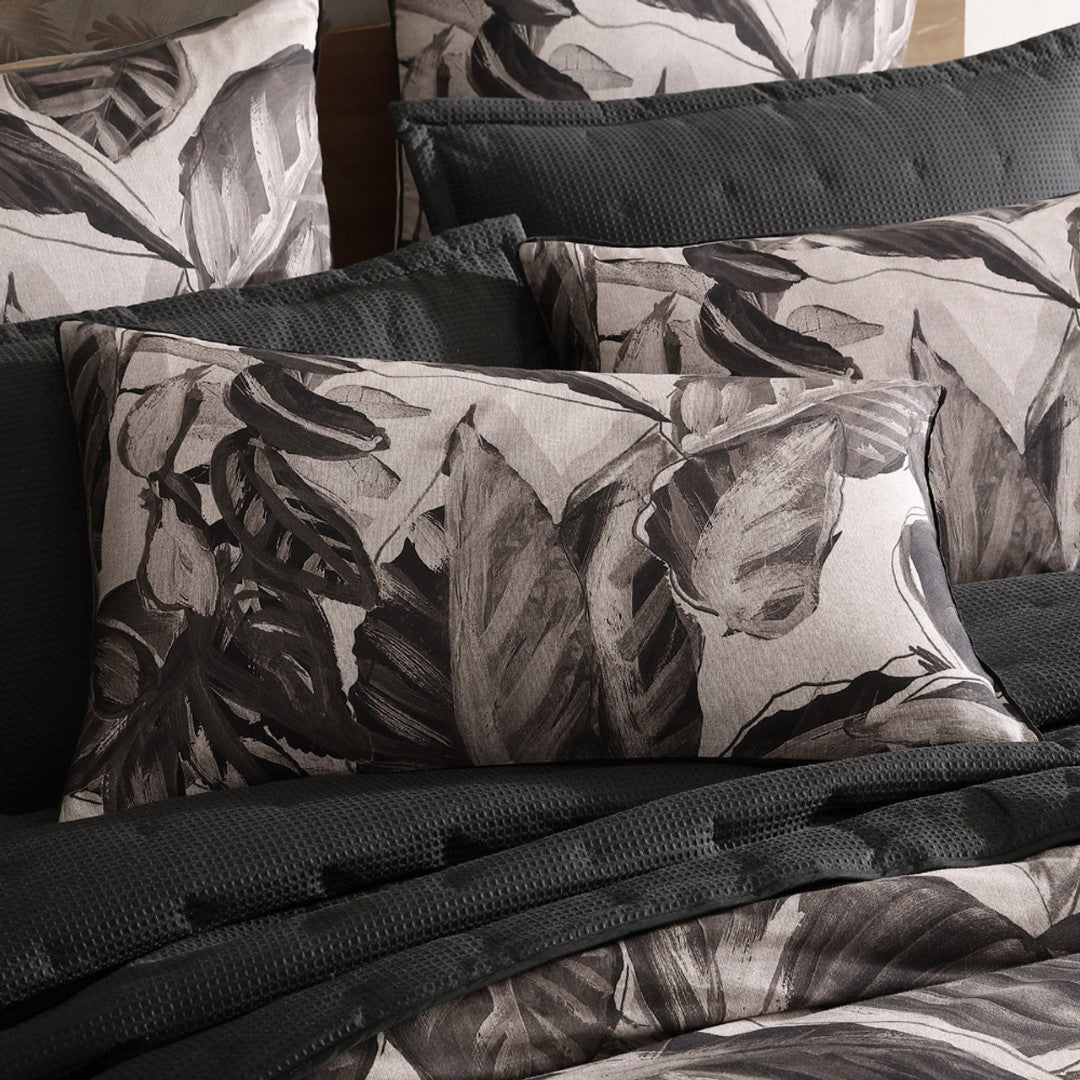 Luxurious King Duvet Cover Set featuring exotic foliage on a soft cotton sateen, with intricate ikat pattern on the reverse.