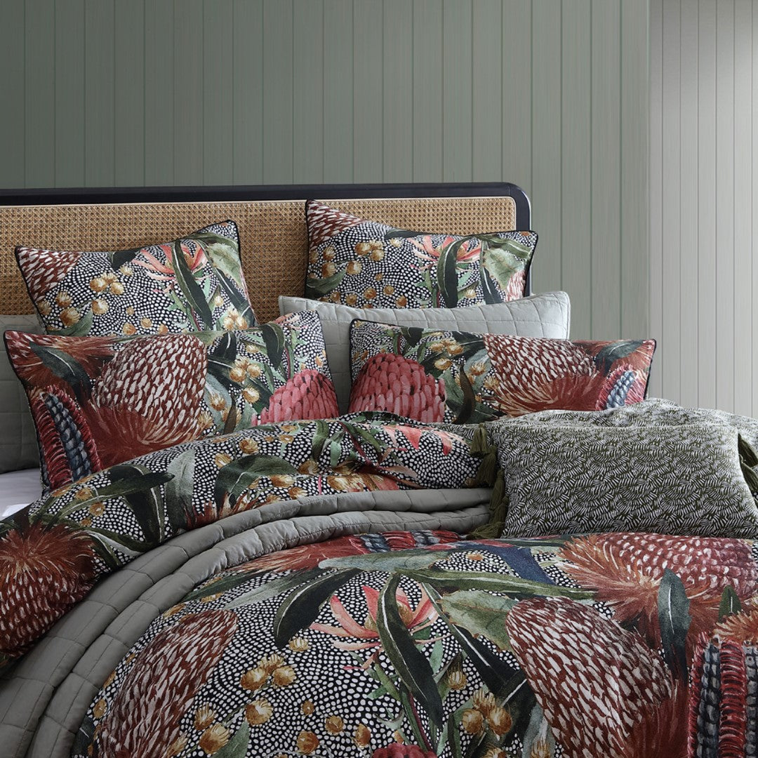 Luxury super king duvet cover set featuring Australian botanical designs in deep red, olive, and ochre colors, made from cotton sateen.