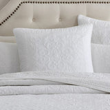 Luxurious ivory Eurosham with quilted design, 100% cotton, self-bound edge, enhancing modern bedroom decor.