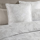 Platinum Grace Dove King Duvet Cover Set featuring stylized hibiscus flowers in soft hues, perfect for a tropical-inspired bedroom.