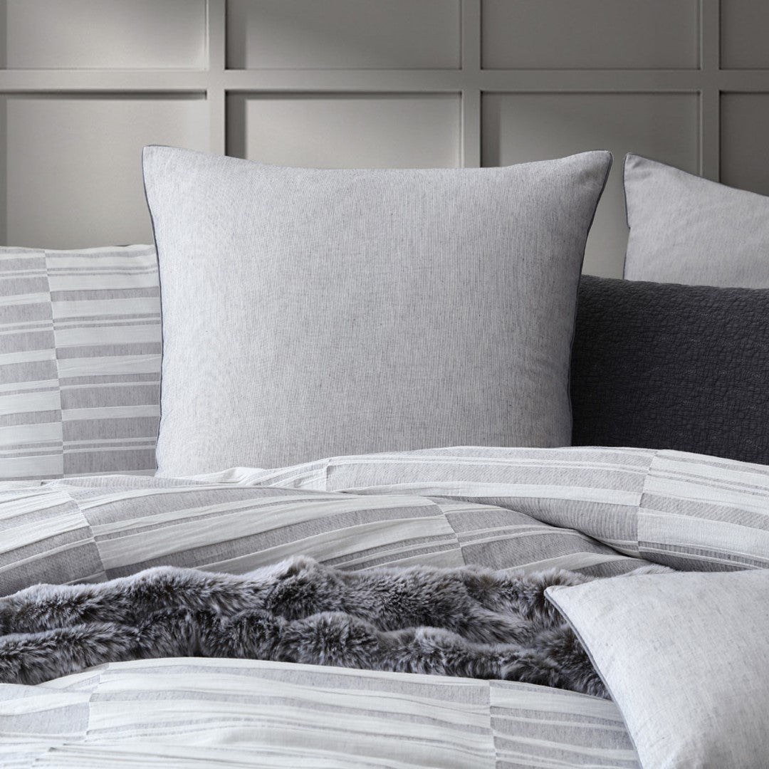 Elegant platinum duvet cover set with textured check pattern, featuring oversized design and piped edges for modern luxury.