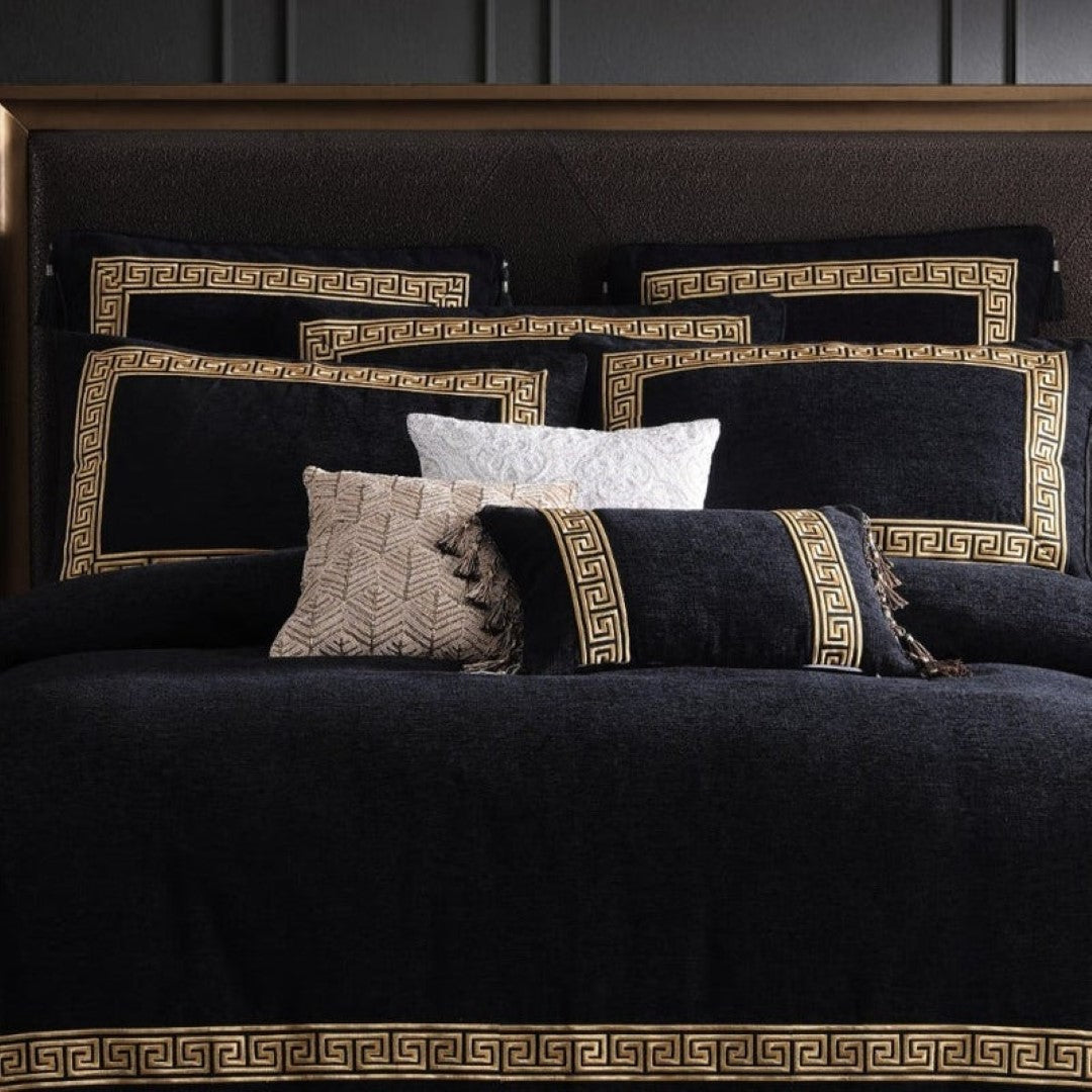 Luxury black cushion with gold-embroidered Greek key design, tassels, and corded piping; perfect for enhancing home decor.