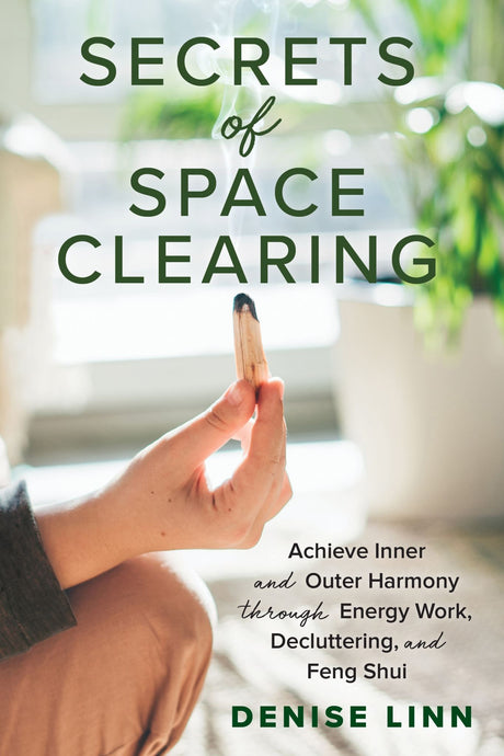 Book cover of "Secrets of Space Clearing" by Denise Linn, showcasing techniques for cleansing and harmonizing living spaces.