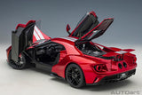 Diecast 1/12 Ford GT model in vibrant Liquid Red with Silver Stripes, showcasing intricate design and craftsmanship.