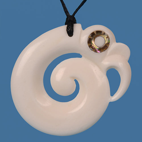 Handcrafted Bone Manaia Pendant featuring intricate design and paua shell inlay, symbolizing protection and new beginnings.