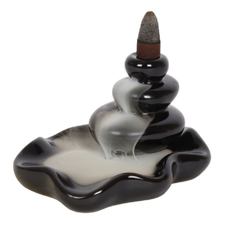 Large black ceramic incense burner designed like stacked pebbles, creating a soothing waterfall smoke effect for relaxation.