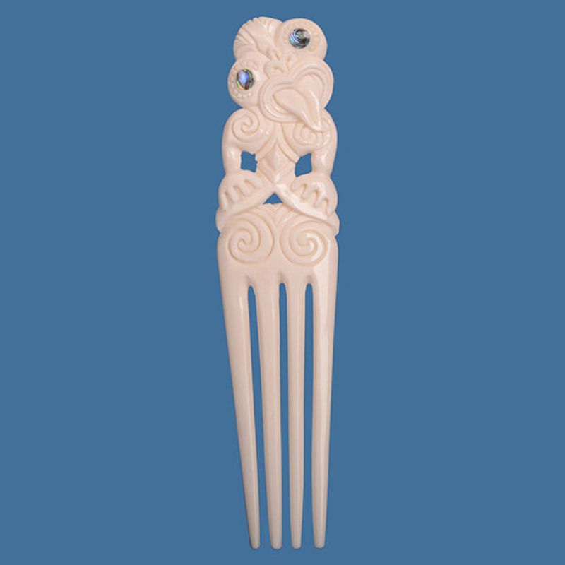 Large Bone Heru pendant with Tiki design, featuring unique paua inlays and symbols of fertility and wisdom, 150mm long.