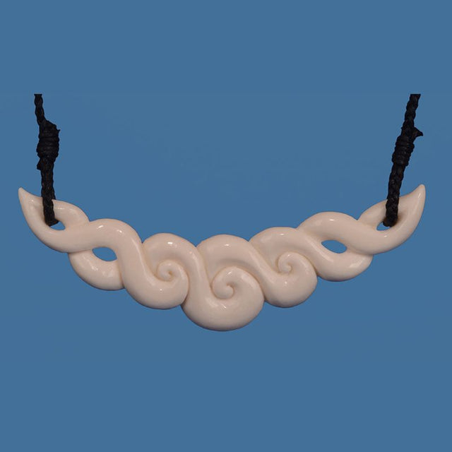 Handcrafted Bone Koru Necklace in Maori design, symbolizing new beginnings with elegant, unique carvings.