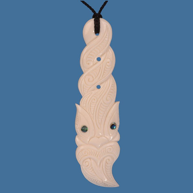 XL Bone Tiki Twist Pendant featuring intricate Maori carvings, adjustable cord, and unique design, perfect for making a bold statement.