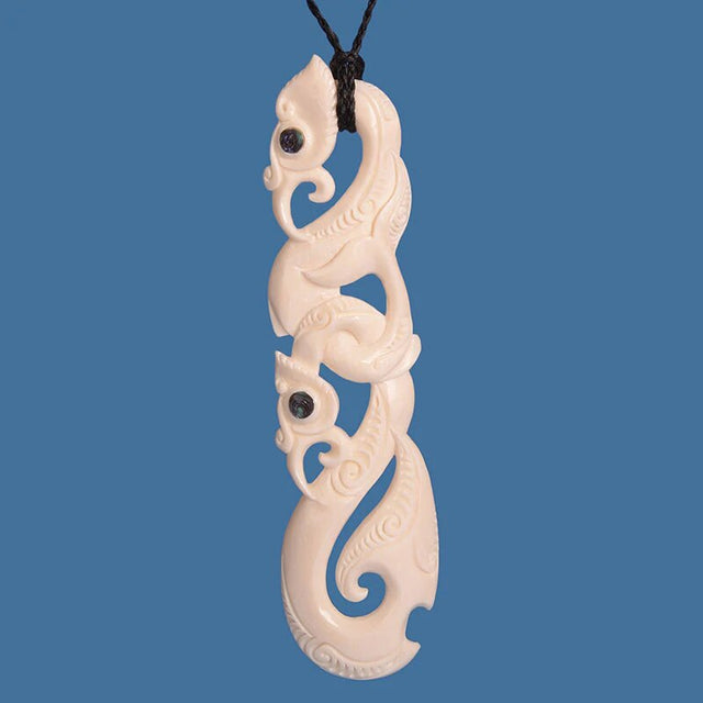 Extra-large Maori bone Manaia pendant on adjustable black cord, symbolizing protection and elegance.