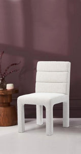 White dining chair with boucle upholstery and birchwood frame, featuring minimalist design for modern dining spaces.