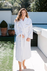 White velour hotel robe with shawl collar, pockets, and waist tie, made from 100% OEKO-TEX® certified cotton.