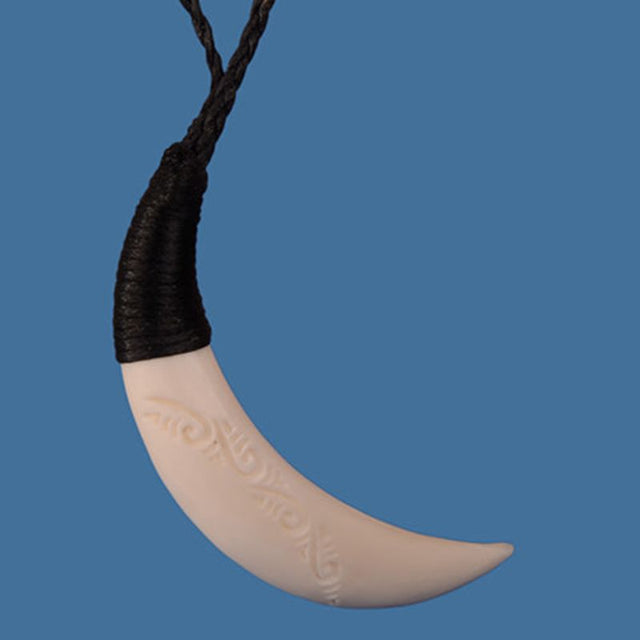 Carved pig tusk pendant, 12 x 80mm, on adjustable braided wax cord, showcasing intricate detailing and elegance.