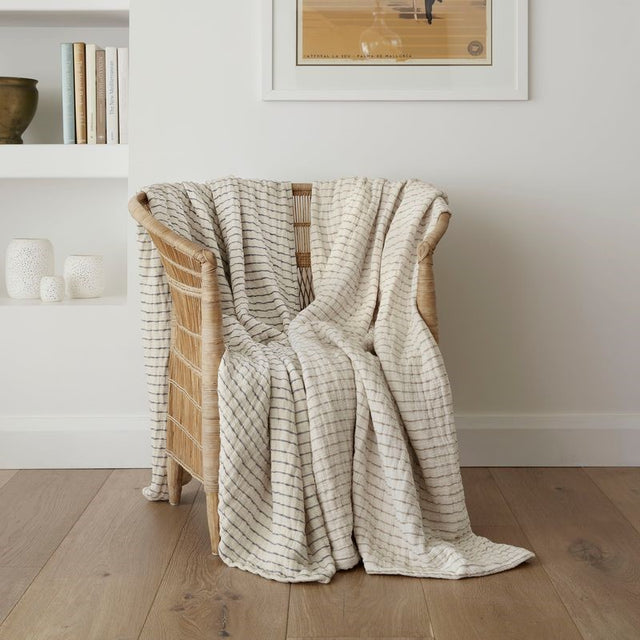 Lightweight reversible throw in cream and beige stripes, made from soft cotton, perfect for cozy evenings.