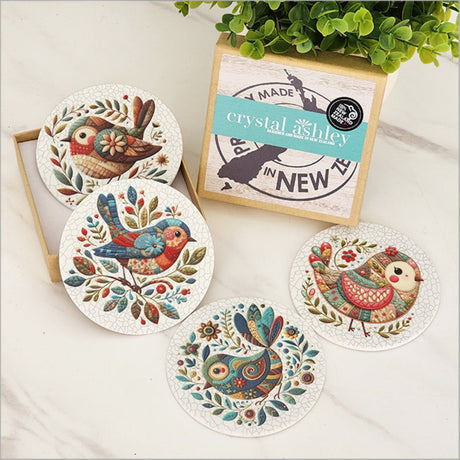 Colorful patchwork bird coasters in a gift box, made from durable acrylic with a cork base for scratch prevention.