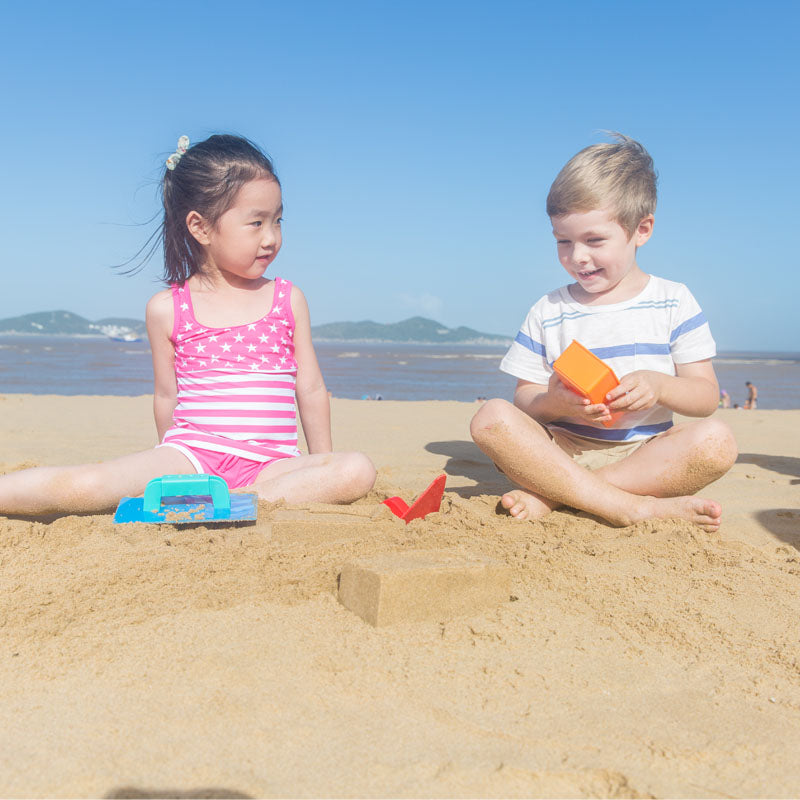 Colorful Hape Master Bricklayer Set for kids 18+ months, fostering creativity and fine motor skills through sandcastle building.