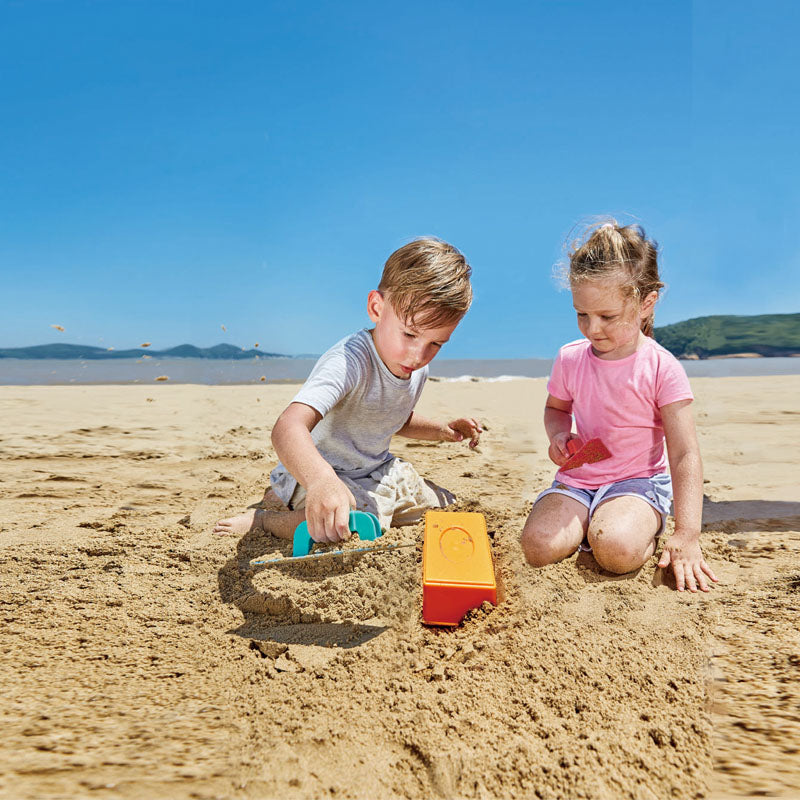 Colorful Hape Master Bricklayer Set for kids 18+ months, featuring non-toxic bricks for creative outdoor sandcastle building.