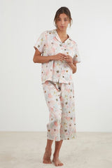 Blush pink sateen Capri PJ set with pressed flower design, featuring a button-up top and cropped pants, ethically made by BAKSANA.