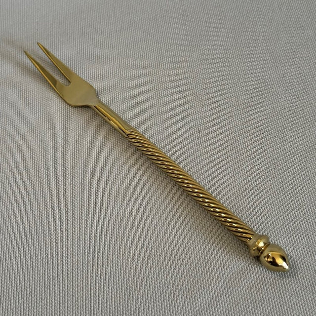 Elegant 14cm brass cocktail fork, perfect for serving appetizers at gatherings with a sophisticated design.