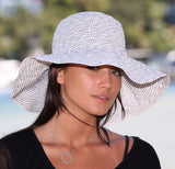 Chic white sun hat with UPF 50+, packable design, adjustable size, and stylish wire brim for ultimate sun protection.