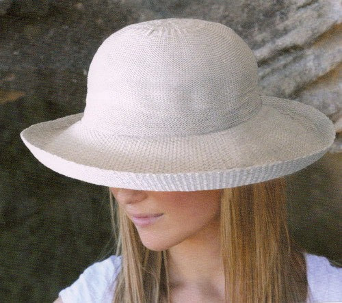 Classic ivory wide-brimmed hat with UPF 50+ protection, stylish turned-up edge, squashable and washable for outdoor elegance.