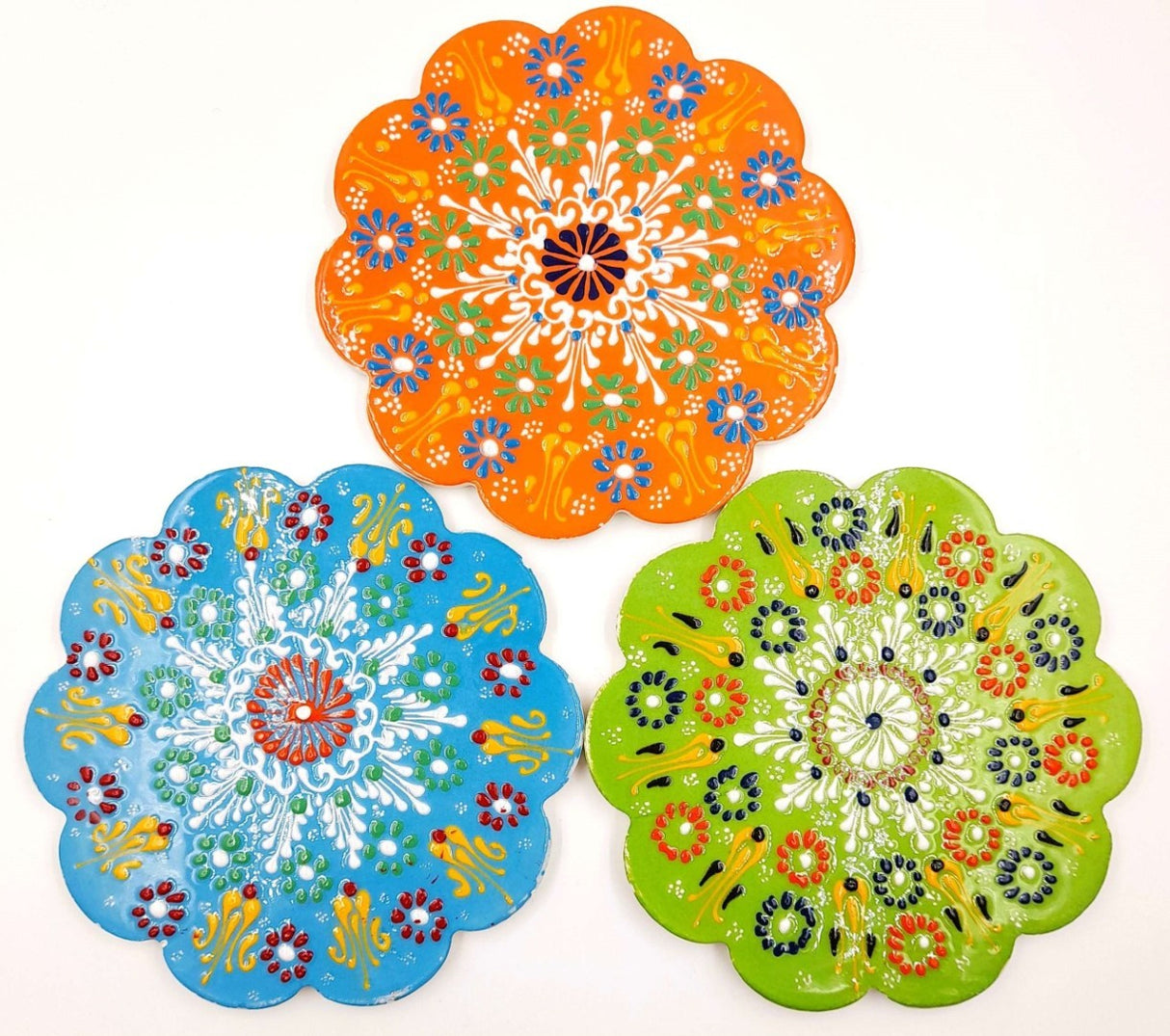 Set of three vibrant 18cm Turkish handpainted trivets, showcasing unique designs for protecting surfaces while enhancing decor.