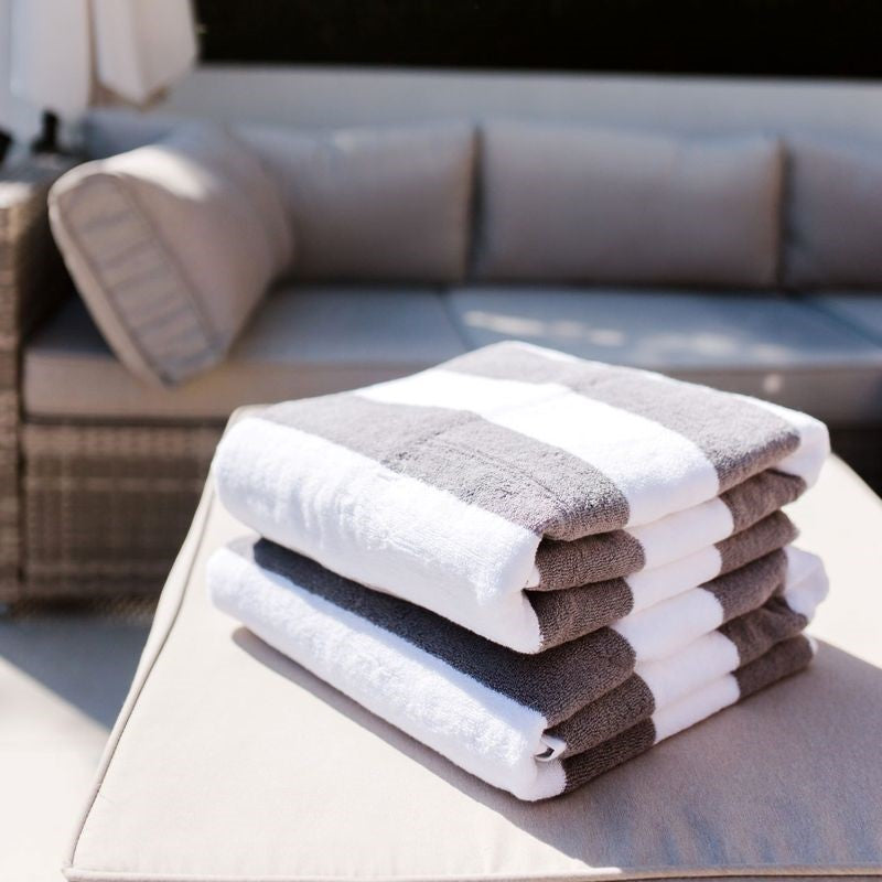 Plush charcoal and white beach towel by Baksana, 100% cotton, 100 x 180cm, soft and absorbent, ideal for water activities.