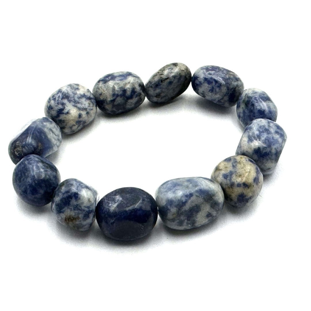 Large beaded bracelet featuring vibrant sodalite in deep blue and white, promoting calmness and style.