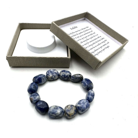 Large sodalite beaded bracelet featuring deep blue and white hues, promoting calmness and style for daily wear or special occasions.