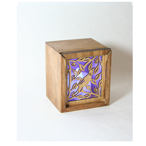 LED Tealight Box - Tui in bamboo with laser-cut nature designs and color-changing LED candle, serving as a holder and trinket box.